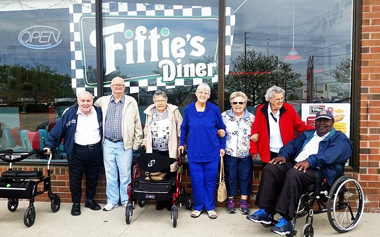 Some Cardinal Retirement residents outside a restaurant called the "Fifties's Diner"